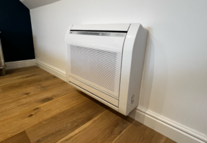 Image shows a newly installed heat pump in a converted loft space