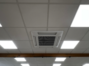 Image shows a newly fitted out office ceiling with air conditioning unit and lights