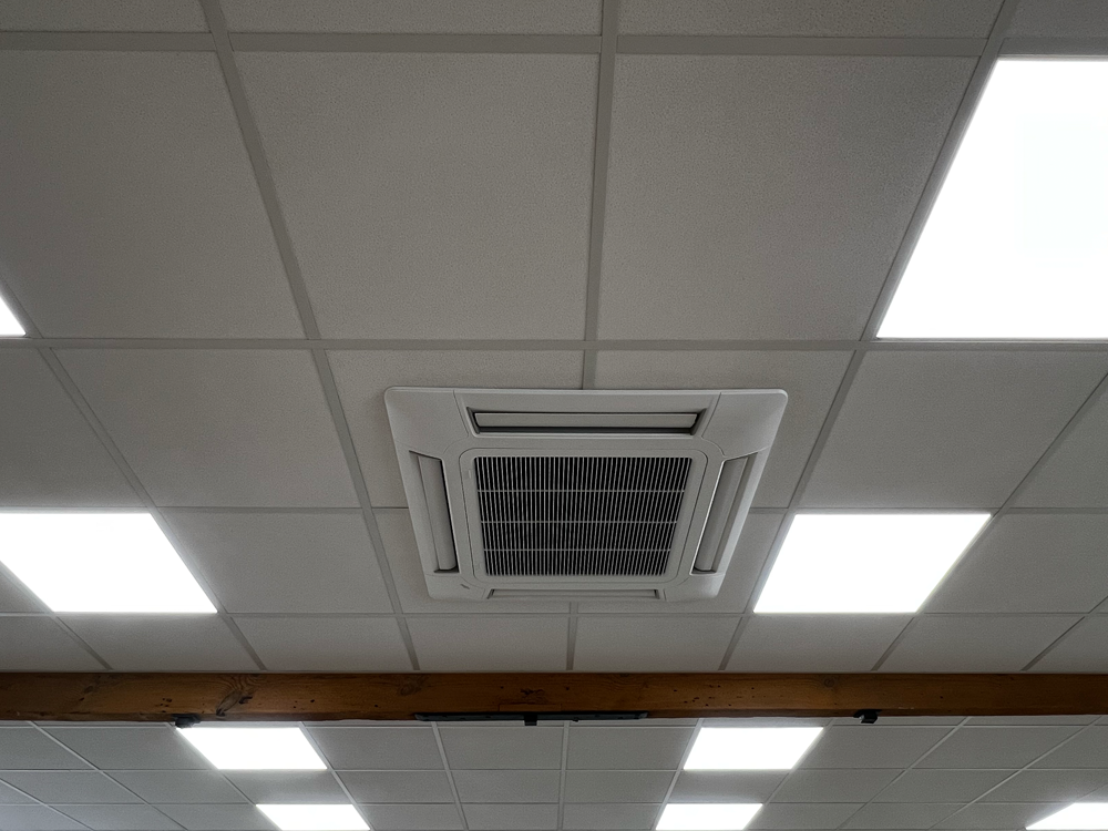 Image shows a newly fitted out office ceiling with air conditioning unit and lights